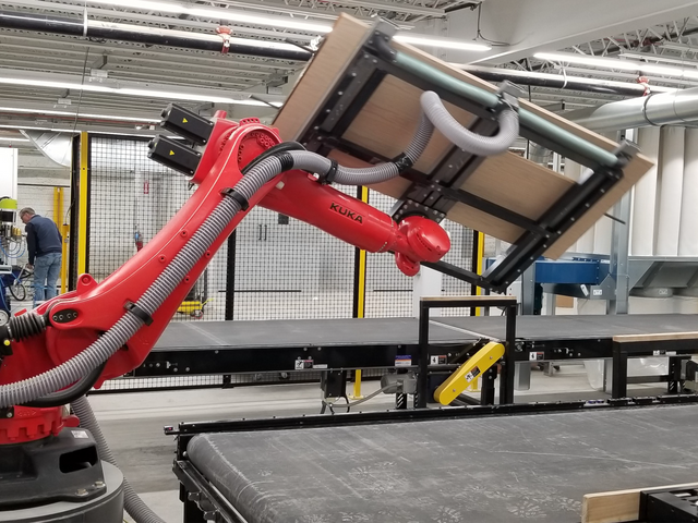 Kuka flips 200-pound doors.