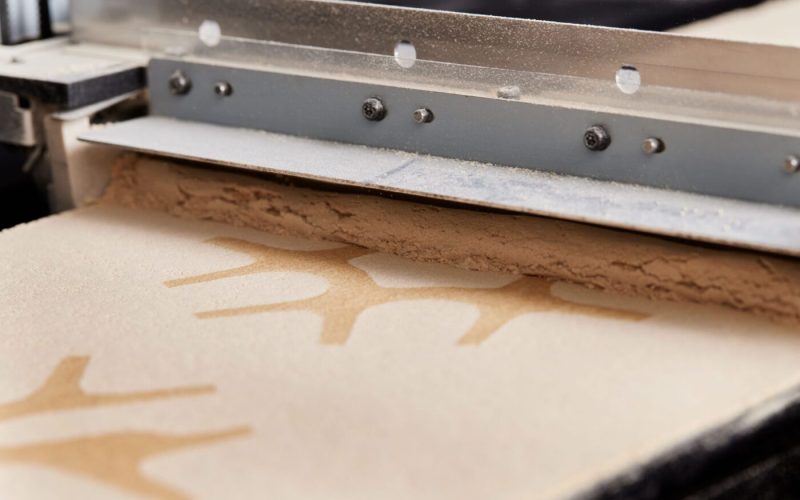 Digital application of lignin to sawdustbinding agent