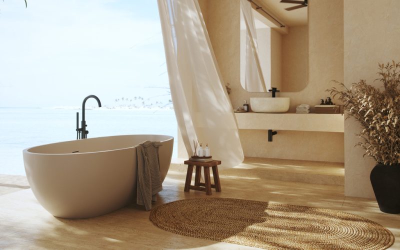 Luxurious bathroom located on a tropical island.
Designed to blend seamlessly with the serene beachfront, it features a freestanding bathtub, sandy hues, and natural textures.